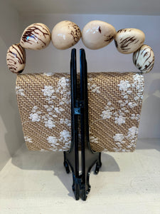 The Nica Rattan Clutch in Cream Flowers