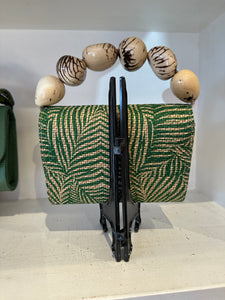 The Nica Rattan Clutch in Palma Green