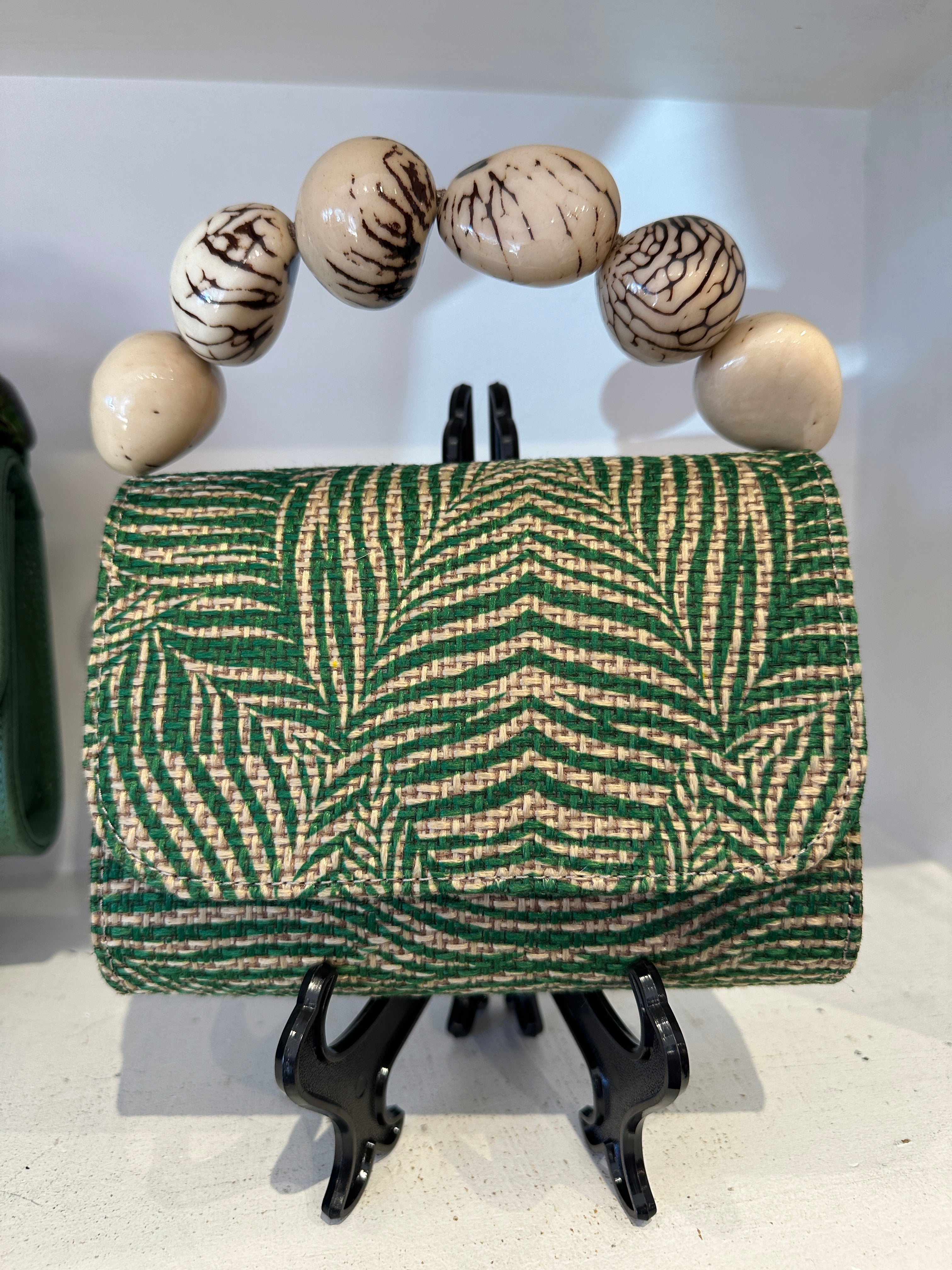 The Nica Rattan Clutch in Palma Green
