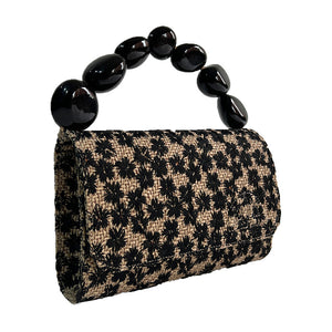 The Nica Rattan Clutch in Black Flowers